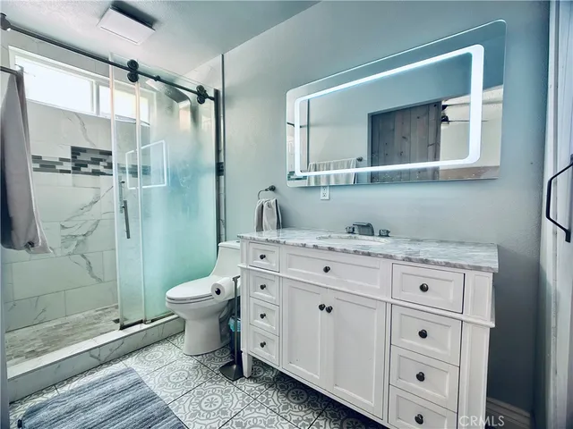 a bedroom with a bed and a lamp next to a window