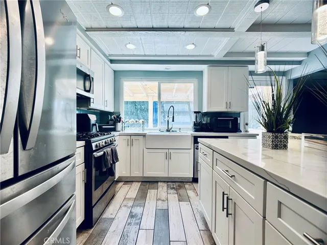 a kitchen with a sink stainless steel appliances and cabinets