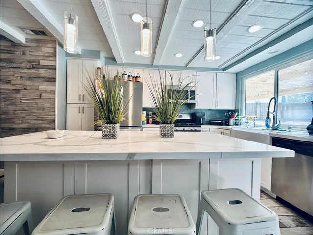 a front view of a house with swimming pool having outdoor seating