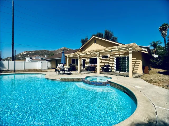 a swimming pool with outdoor seating and yard