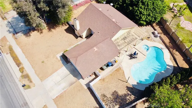 an aerial view of a house with a swimming pool