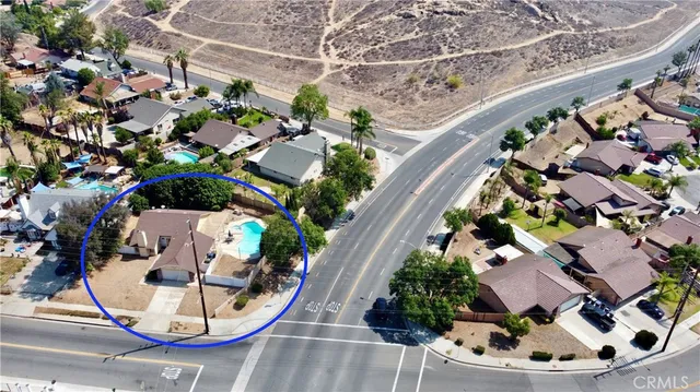 an aerial view of a house with a yard and outdoor seating