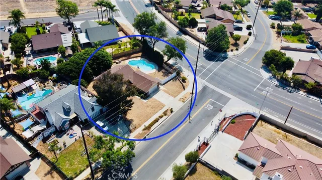 an aerial view of a house with a yard and potted plants