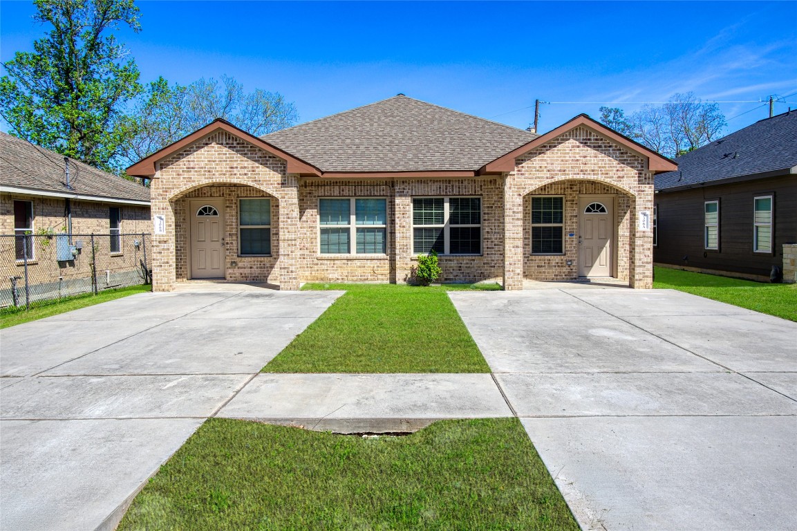 9306 Bean Street, Unit B Houston, TX 77028 - Photo 1 of 15 a view of a white house with a yard and large tree