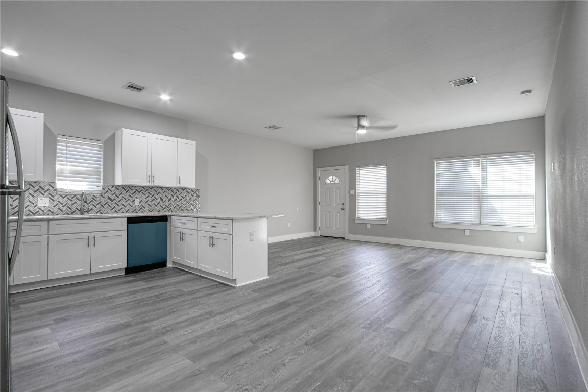 9306 Bean Street, Unit B Houston, TX 77028 - Photo 11 of 15 a large kitchen with hard wood floors and white stainless steel appliances
