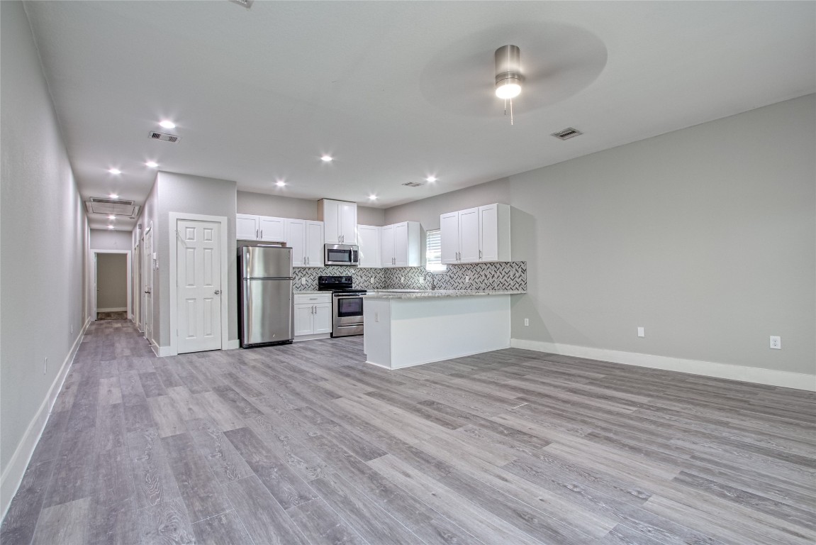 9306 Bean Street, Unit B Houston, TX 77028 - Photo 14 of 15 a view of kitchen appliances wooden floor and window