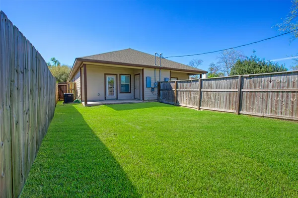 a view of a house with a yard and sitting area