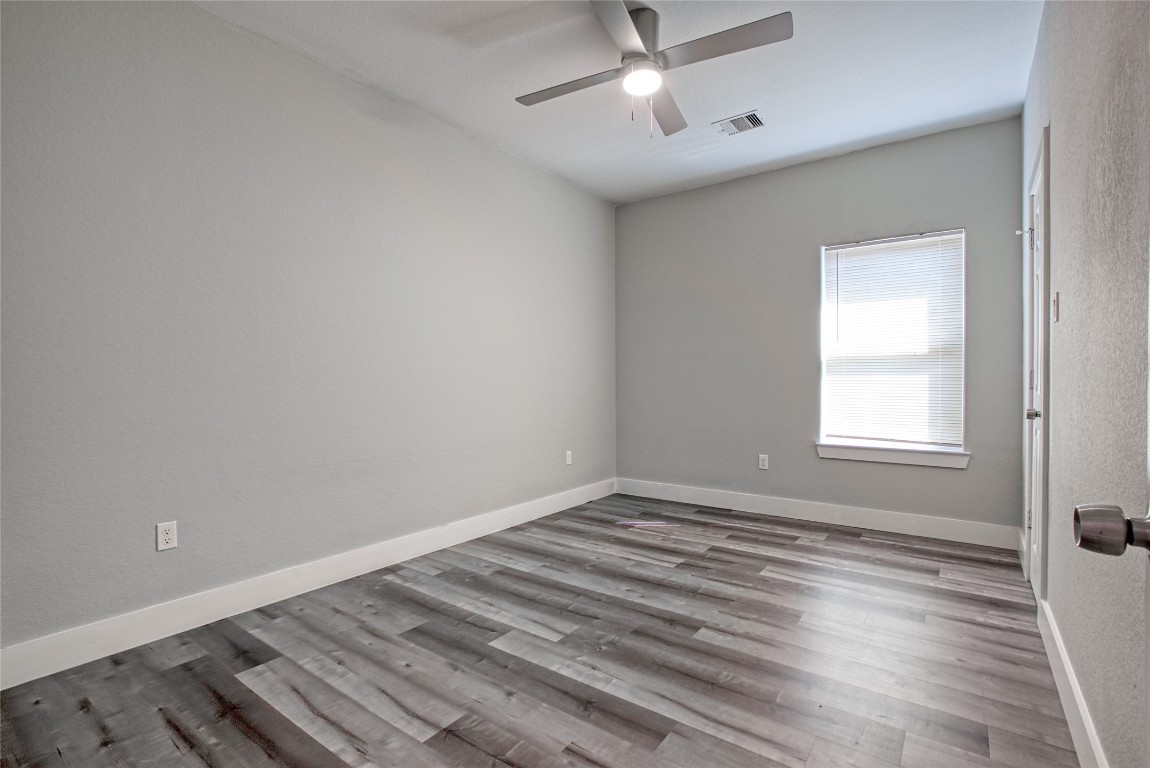 9306 Bean Street, Unit B Houston, TX 77028 - Photo 7 of 15 wooden floor in an empty room with a window