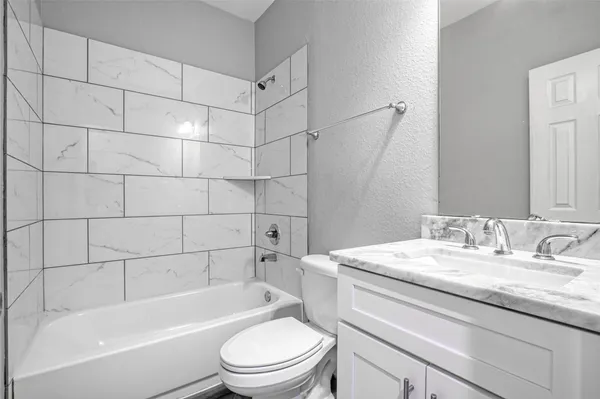 a bathroom with a sink a toilet and bathtub