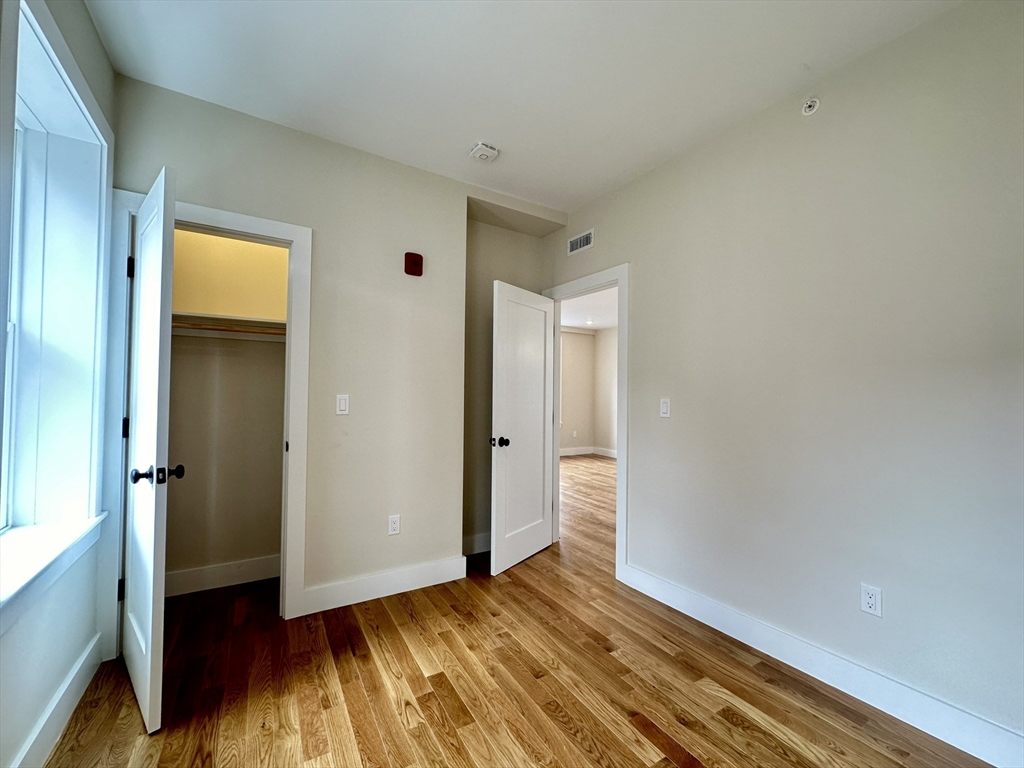 64 North Margin Street, Unit 4R Boston, MA 02113 - Photo 11 of 18 a view of an empty room with closet and wooden floor