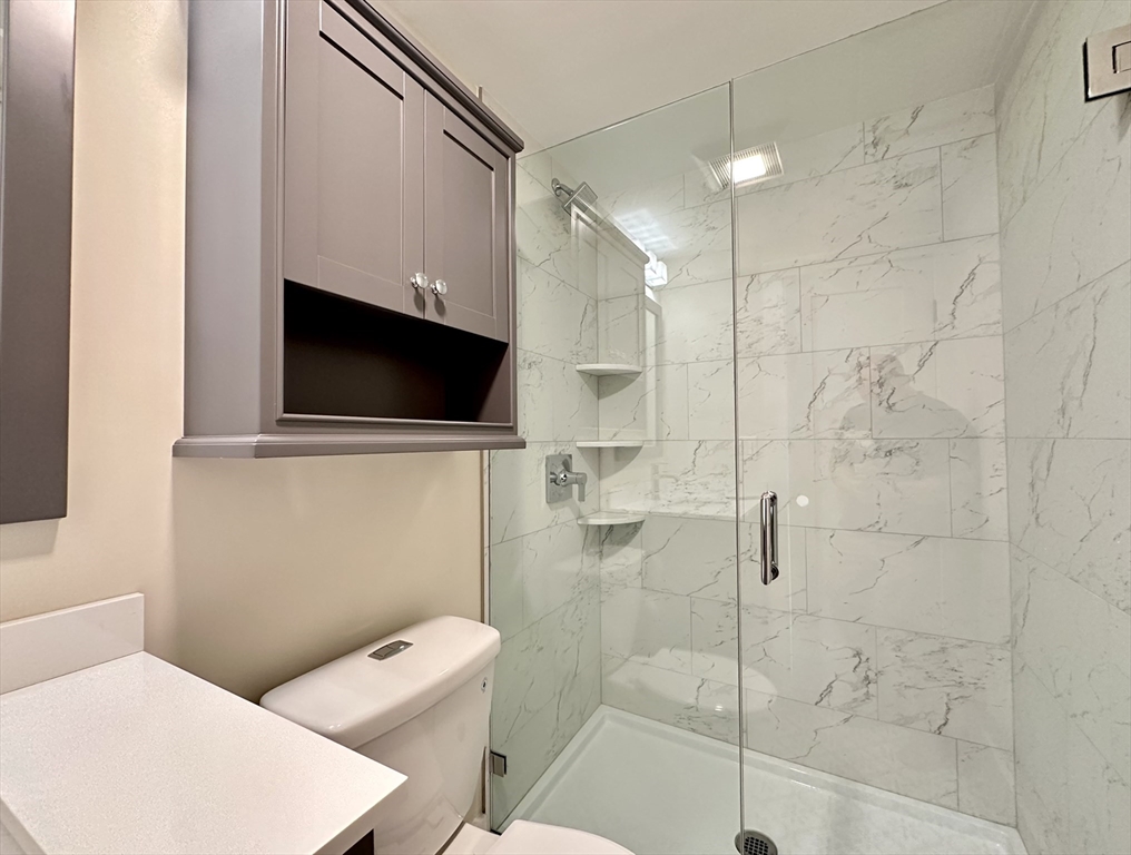 64 North Margin Street, Unit 4R Boston, MA 02113 - Photo 15 of 18 a bathroom with a shower a toilet and a sink