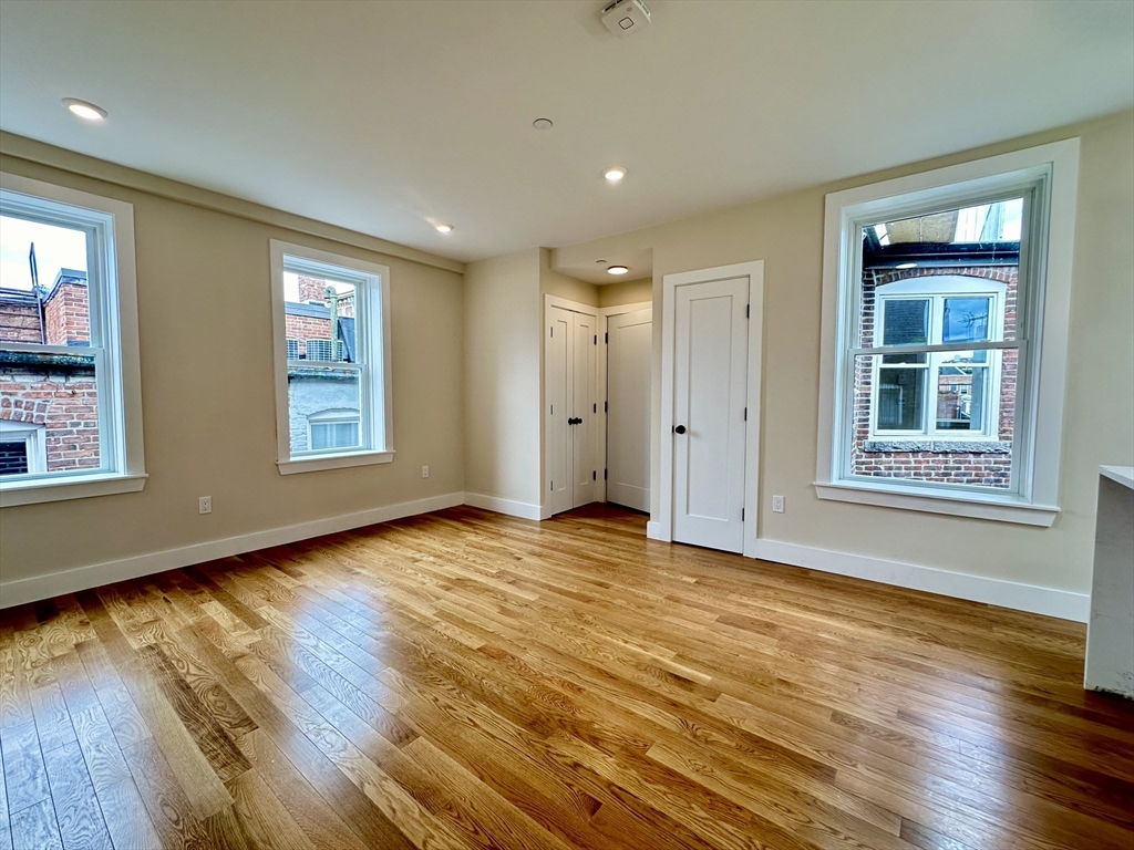 64 North Margin Street, Unit 4R Boston, MA 02113 - Photo 4 of 18 an empty room with wooden floor and windows