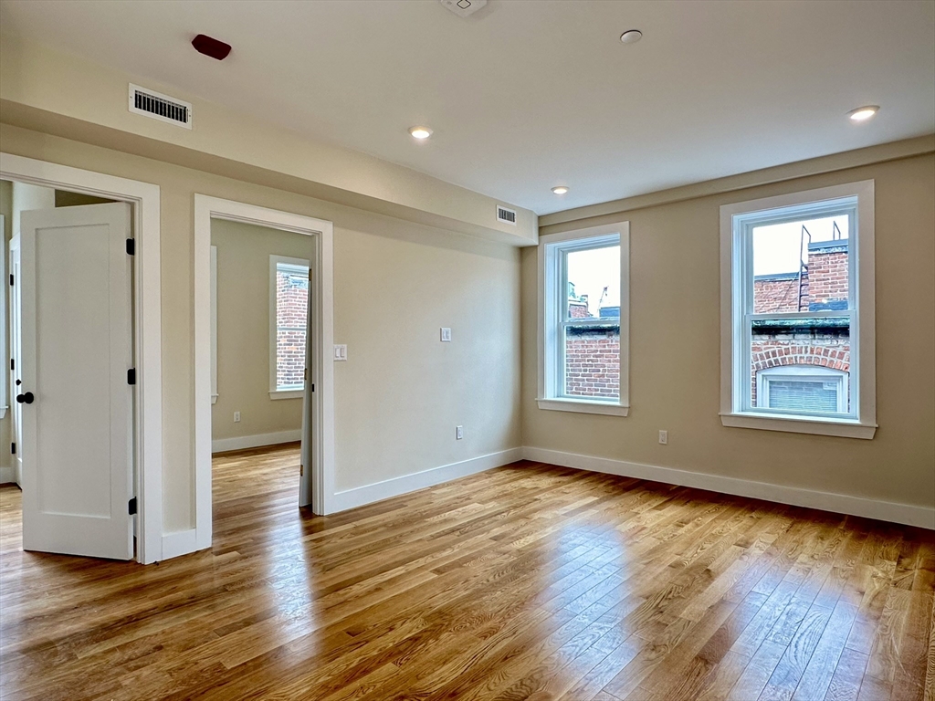 64 North Margin Street, Unit 4R Boston, MA 02113 - Photo 8 of 18 a view of an empty room with wooden floor and a window
