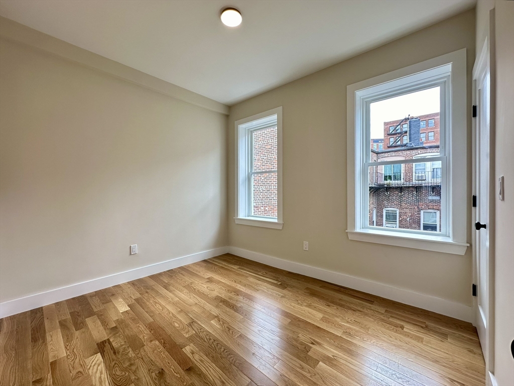 64 North Margin Street, Unit 4R Boston, MA 02113 - Photo 9 of 18 a view of an empty room with wooden floor and a window
