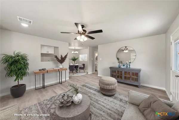 a living room with furniture and a potted plant