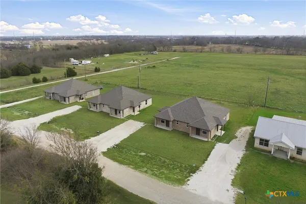 an aerial view of a house with a garden and pool view