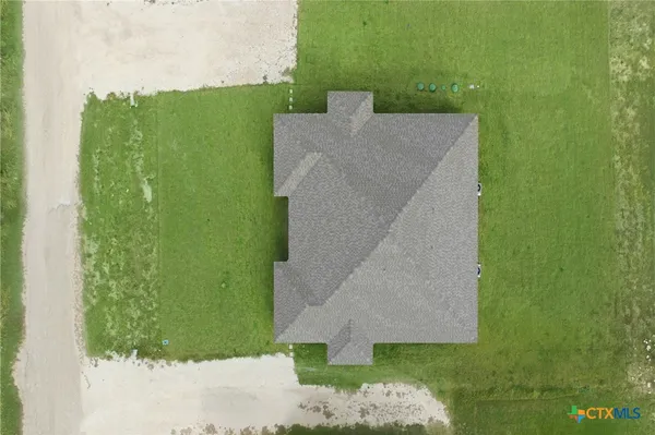 an aerial view of a house with a yard