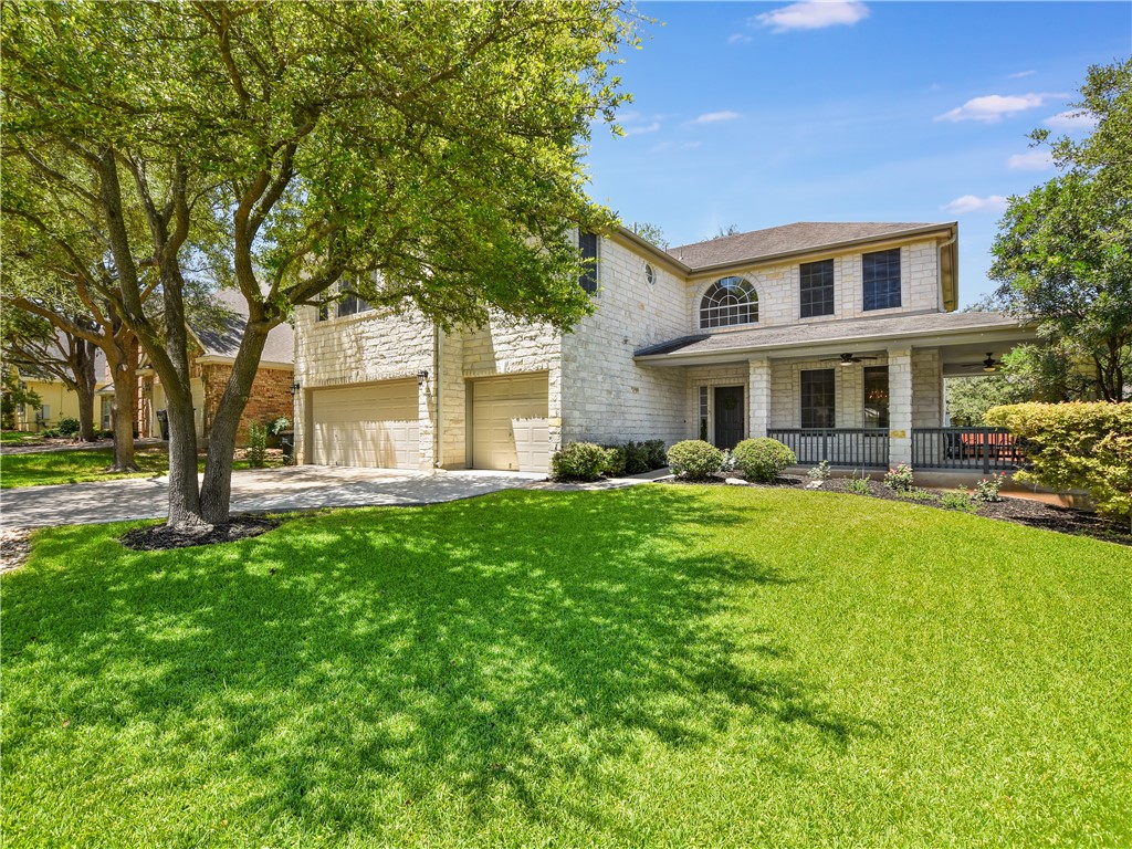 a front view of a house with yard and green space