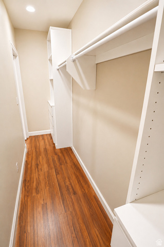 1055 North 1000 East Mapleton, UT 84664 - Photo 49 of 112 Organized closet system featuring wood-finish flooring, built-in shelving, integrated drawers, and multiple hanging rods
