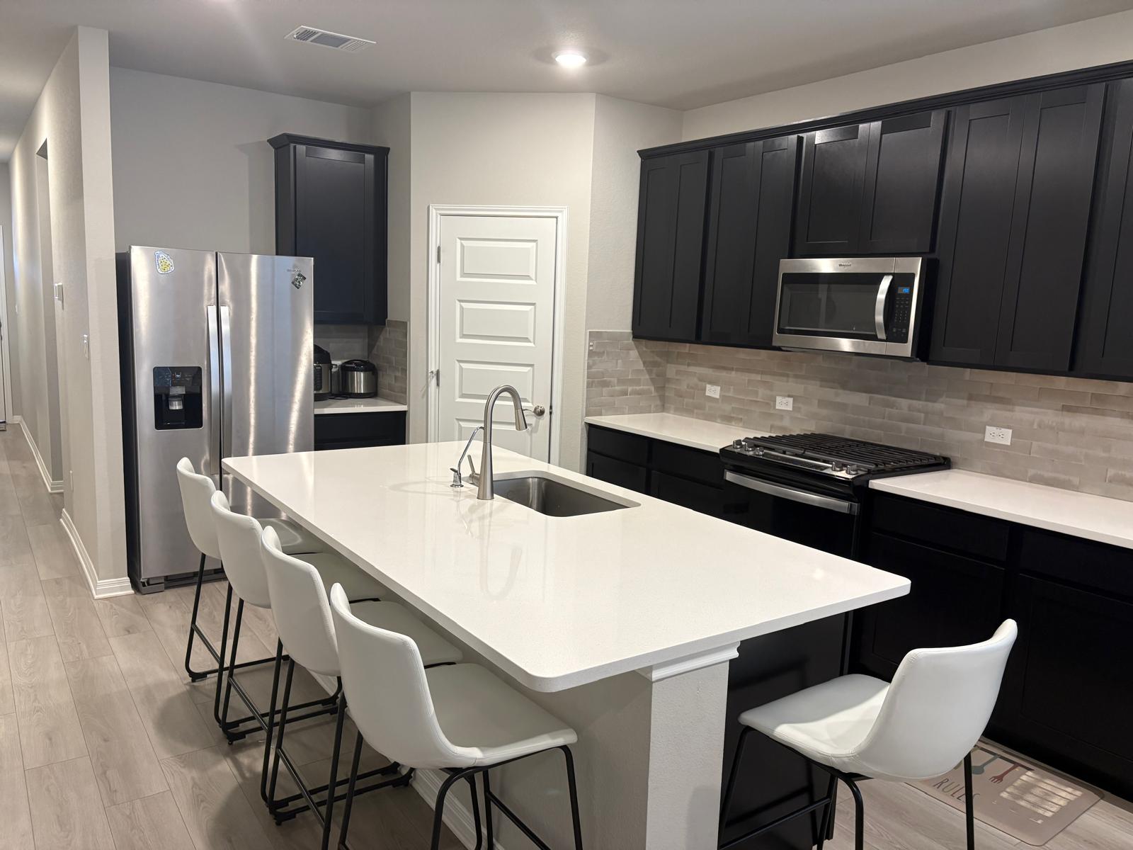 6511 Dragride Road Buda, TX 78610 - Photo 10 of 36 Culinary delights await in this sleek kitchen featuring a generous island and modern fixtures.