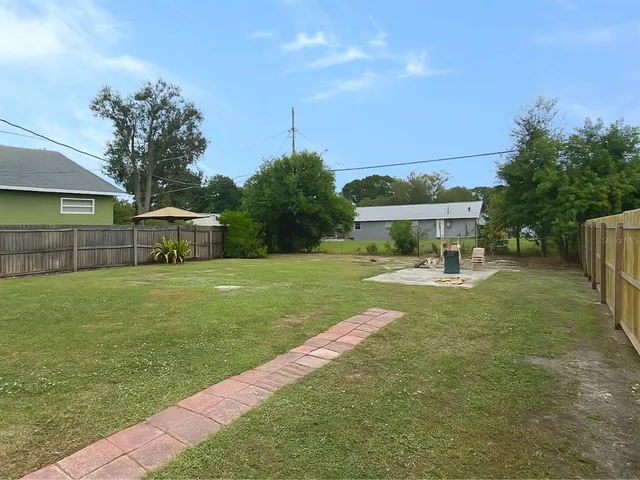 a view of house with backyard space and garden
