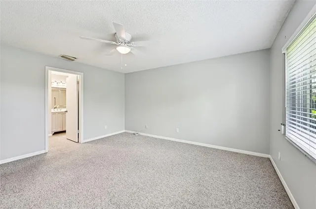 a view of an empty room with a ceiling fan