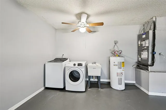 a view of a hallway with a chandelier fan and windows