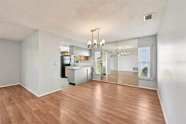 a view of a kitchen and dining room with wooden floor