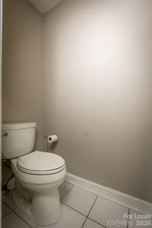 a white toilet sitting next to a shower