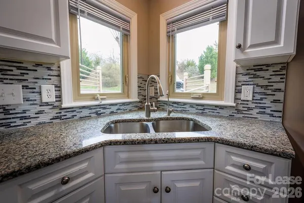 a kitchen with granite countertop a sink and a window