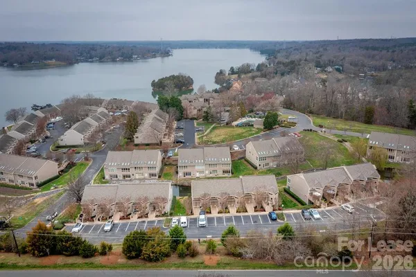 an aerial view of multiple house with lake view