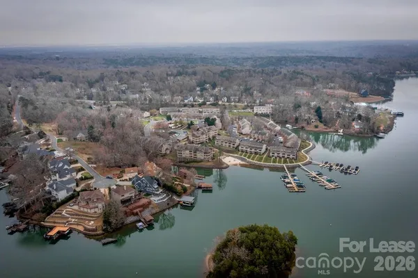 an aerial view of a house with a lake view