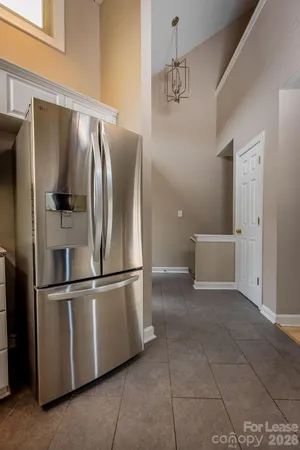 a metallic refrigerator freezer sitting in a kitchen