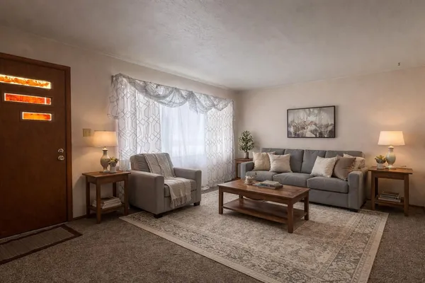 a living room with furniture and a window