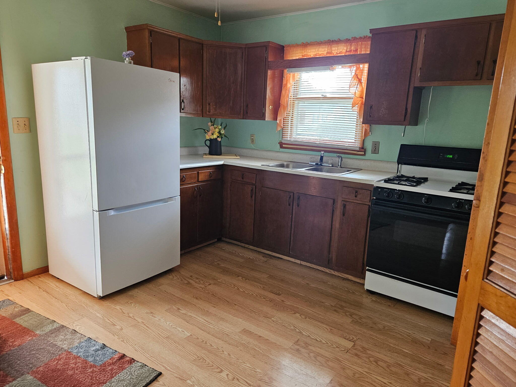 606 North Race Street Monon, IN 47959 - Photo 4 of 14 a kitchen with a refrigerator stove and sink