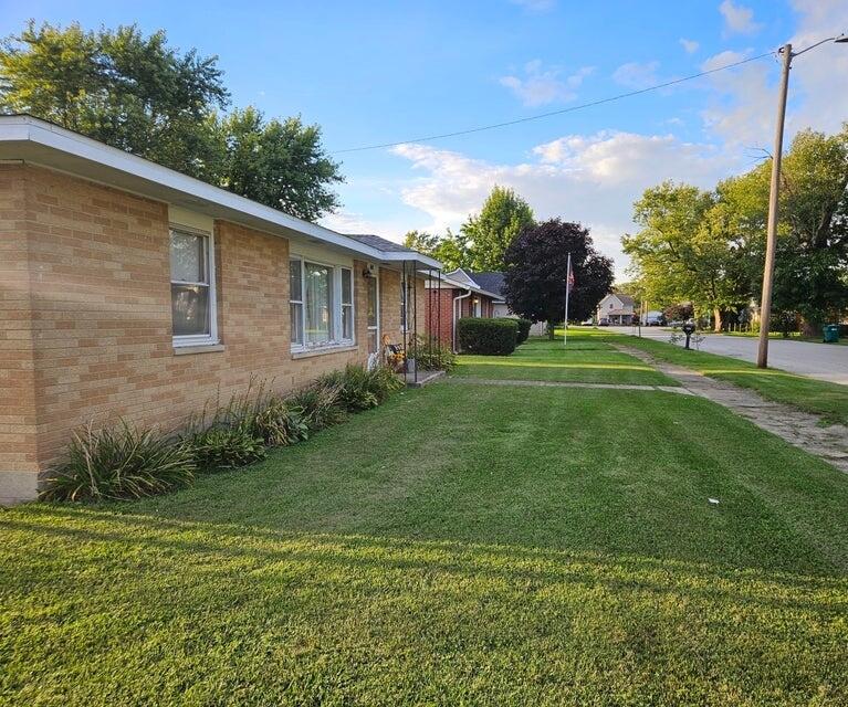 606 North Race Street Monon, IN 47959 - Photo 10 of 14 a backyard of a house with plants and large trees