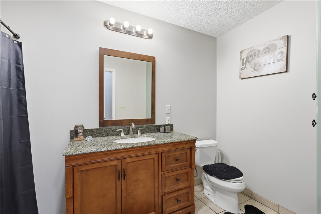 941 Scotland Road Easley, SC 29640 - Photo 15 of 25 A well-appointed bathroom offers a vanity with granite counters and a clean, functional layout.