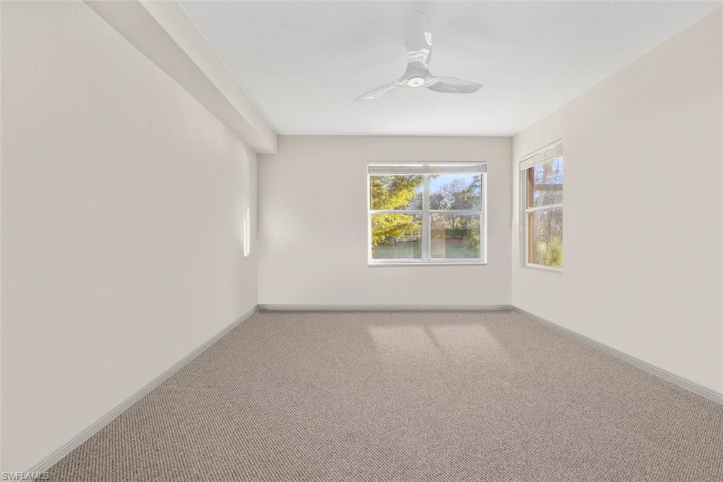 348 Dover Place, Unit C103 Naples, FL 34104 - Photo 12 of 27 an empty room that has a window