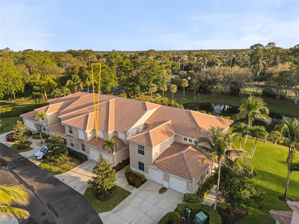 348 Dover Place, Unit C103 Naples, FL 34104 - Photo 19 of 27 a view of a lake with a mountain in the background