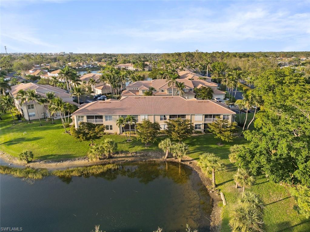 348 Dover Place, Unit C103 Naples, FL 34104 - Photo 21 of 27 a view of a lake with a building in the background