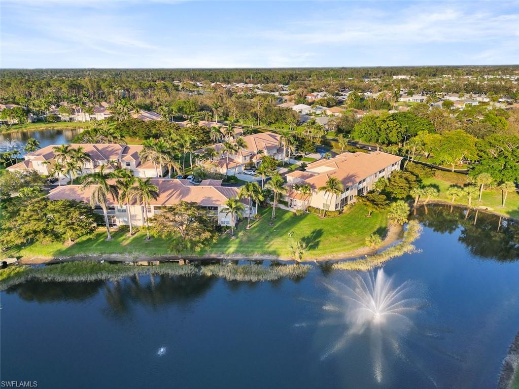 348 Dover Place, Unit C103 Naples, FL 34104 - Photo 22 of 27 an aerial view of residential houses with outdoor space and lake view