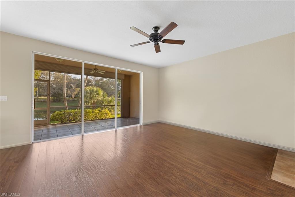 348 Dover Place, Unit C103 Naples, FL 34104 - Photo 3 of 27 a view of a room with wooden floor and a window