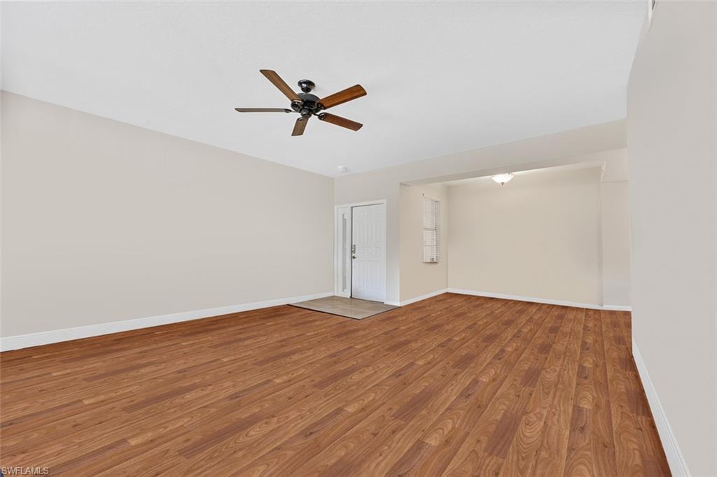 348 Dover Place, Unit C103 Naples, FL 34104 - Photo 6 of 27 a view of a big room with wooden floor and windows