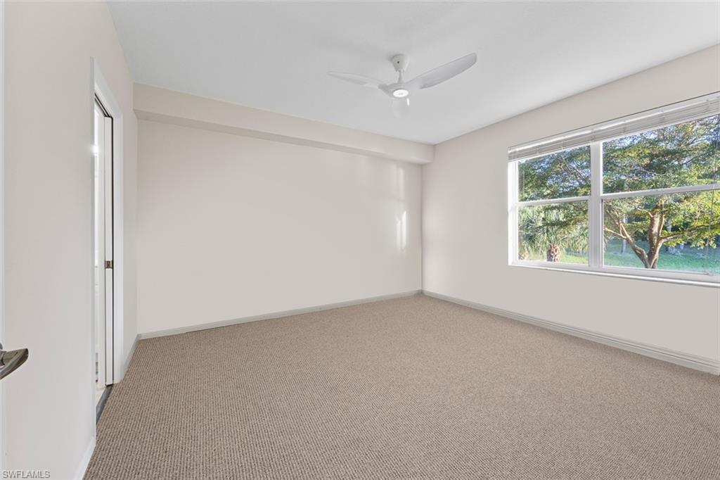 348 Dover Place, Unit C103 Naples, FL 34104 - Photo 9 of 27 a view of an empty room with a window