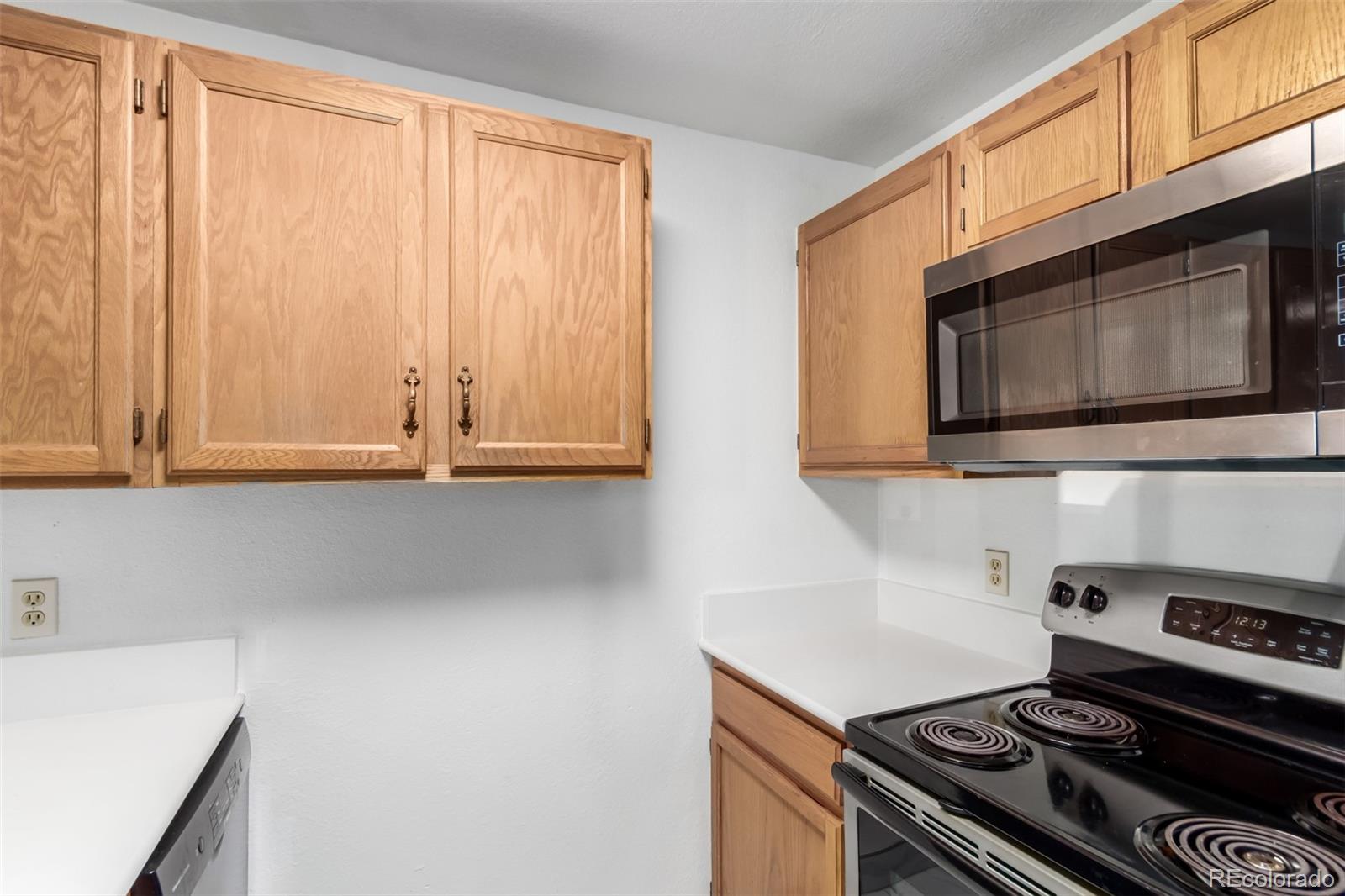 4855 Edison Avenue, Unit 112 Boulder, CO 80301 - Photo 9 of 20 a kitchen with granite countertop a stove and a microwave