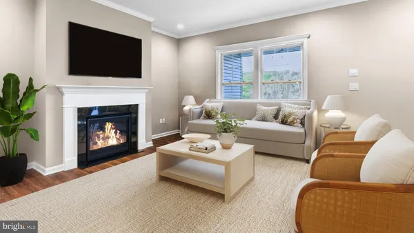 a living room with furniture a flat screen tv and a fireplace