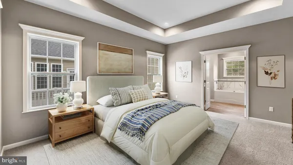 a spacious bedroom with a bed and a couch