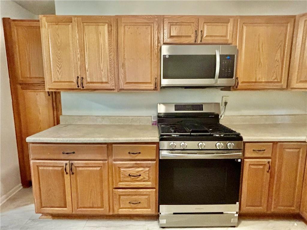 269 Florida Avenue Southwest Atlanta, GA 30310 - Photo 8 of 11 a kitchen with granite countertop a stove and a microwave