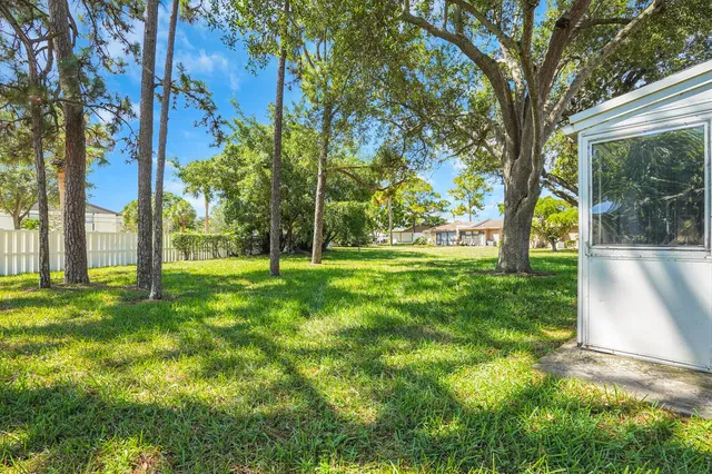 a view of house with backyard and swimming pool