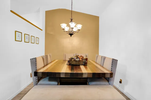 a view of a dining room with furniture and chandelier